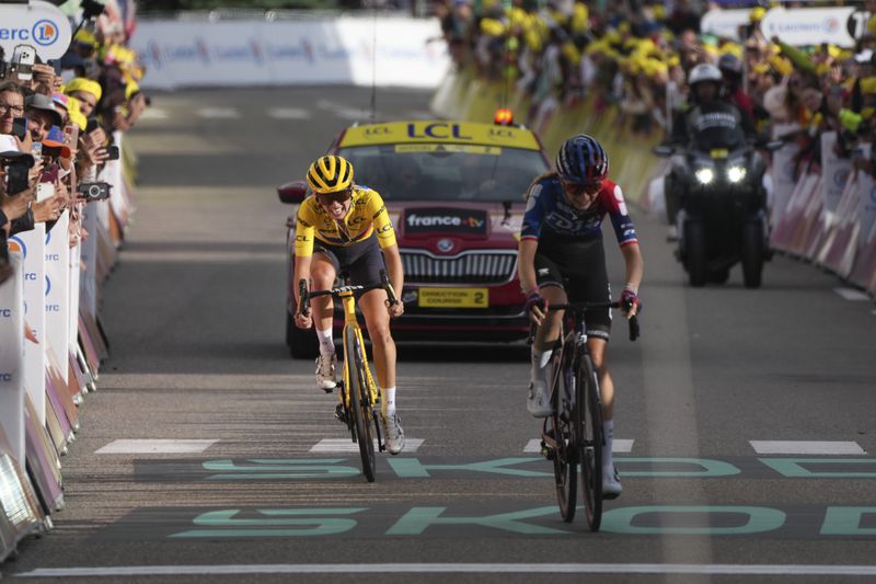 Overall winner Katarzyna Niewiadoma of Poland sprints to the finish line to retain her yellow jersey in the eighth stage of the Tour de France Women cycling race with start in Le Grand-Bornand and finish in Alpe d'Huez, France, Sunday, Aug. 18, 2024. (AP Photo/Peter Dejong)