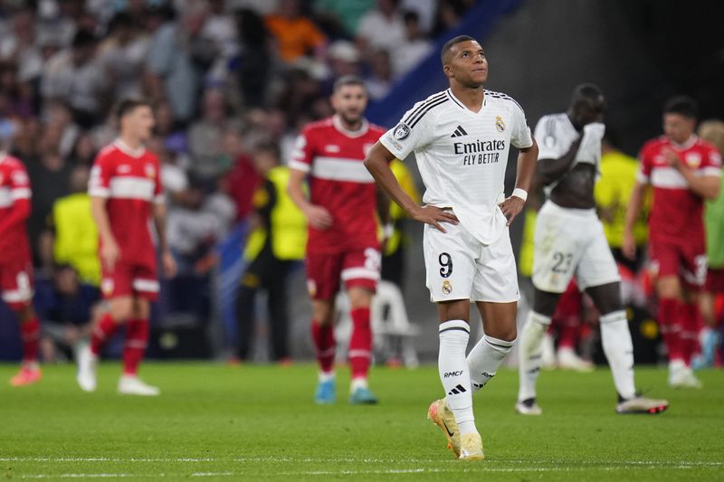 Real Madrid's Kylian Mbappe walks along the pitch after Stuttgart score its side's first goal during the Champions League opening phase soccer match between Real Madrid and VfB Stuttgart at the Santiago Bernabeu stadium, in Madrid, Tuesday, Sept. 17, 2024. (AP Photo/Manu Fernandez)