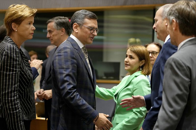 Ukraine's Foreign Minister Dmytro Kuleba, center left, greets from left, Latvia's Foreign Minister Baiba Braze, Romania's Foreign Minister Luminita-Teodora Odobescu and Ireland's Foreign Minister Micheal Martin during a meeting of EU foreign ministers at the European Council building in Brussels, Thursday, Aug. 29, 2024. (AP Photo/Virginia Mayo)