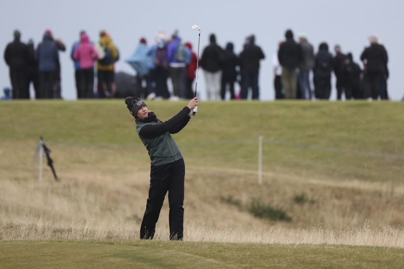 Nelly Korda, of the United States, plays her shot form the 12th fairway during the final round of the Women's British Open golf championship, in St. Andrews, Scotland, Sunday, Aug. 25, 2024. (AP Photo/Scott Heppell)