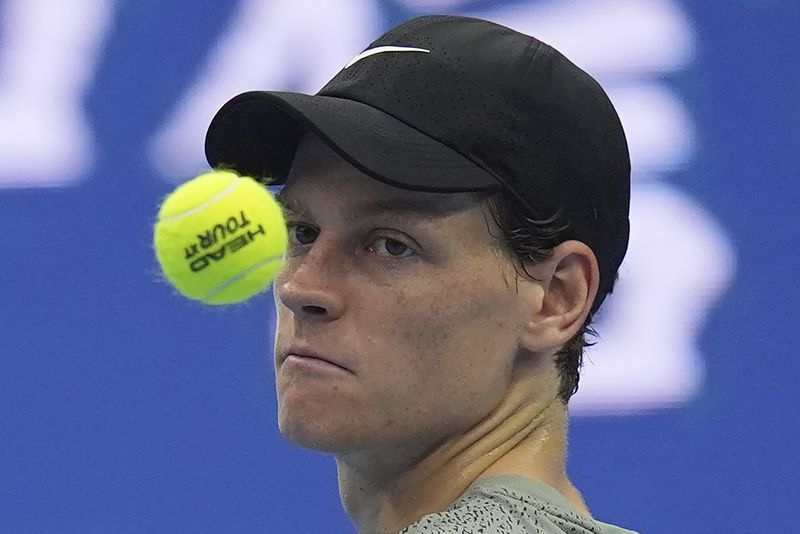 Jannick Sinner of Italy tosses a ball as he waits for play against Roman Safiullin of Russia during the China Open tennis tournament held at the National Tennis Center in Beijing, Saturday, Sept. 28, 2024. (AP Photo/Ng Han Guan)