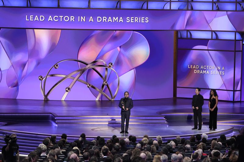 Hiroyuki Sanada accepts the award for outstanding lead actor in a drama series for "Shogun" during the 76th Primetime Emmy Awards on Sunday, Sept. 15, 2024, at the Peacock Theater in Los Angeles. Steven Yeun looks on from right.(AP Photo/Chris Pizzello)