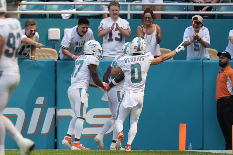 Miami Dolphins wide receiver Jaylen Waddle (17), Miami Dolphins wide receiver Braxton Berrios (0) celebrate a touchdown by Miami Dolphins wide receiver Tyreek Hill (10) during the second half of an NFL football game, Sunday, Sept. 8, 2024, in Miami Gardens, Fla. (AP Photo/Rebecca Blackwell)