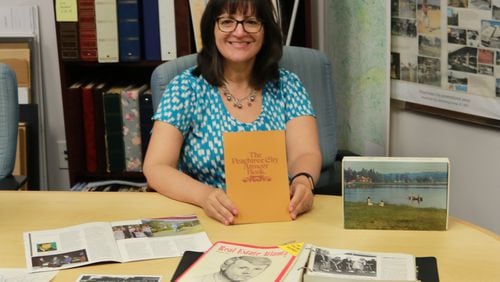 Peachtree City library administrator Jill Prouty shows off some of the historical artifacts already donated to its collection. Courtesy Peachtree City