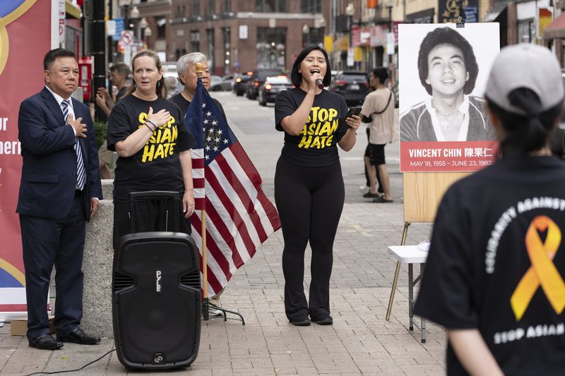 Armaya Doremi, center, sings the national anthem beside Ken Chia, left, Boston City Councilor Erin Murphy, second from left, and Wilson Lee, third from left, during a remembrance ceremony for Vincent Chin, Sunday, June 23, 2024, in Boston. Over the weekend, vigils were held across the country to honor the memory of Chin, who was killed by two white men in 1982 in Detroit. (AP Photo/Michael Dwyer)