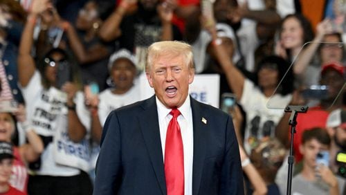 Former President Donald Trump reacts as he takes on the stage during a rally at the Georgia State University’s convocation center on Saturday, August 3, 2024 in Atlanta. Former President Donald Trump and Vice-Presidential candidate JD Vance are holding their first rally together in Georgia on Saturday at the same place – the GSU Convocation Center- Kamala Harris held hers earlier this week.  (Hyosub Shin / AJC)