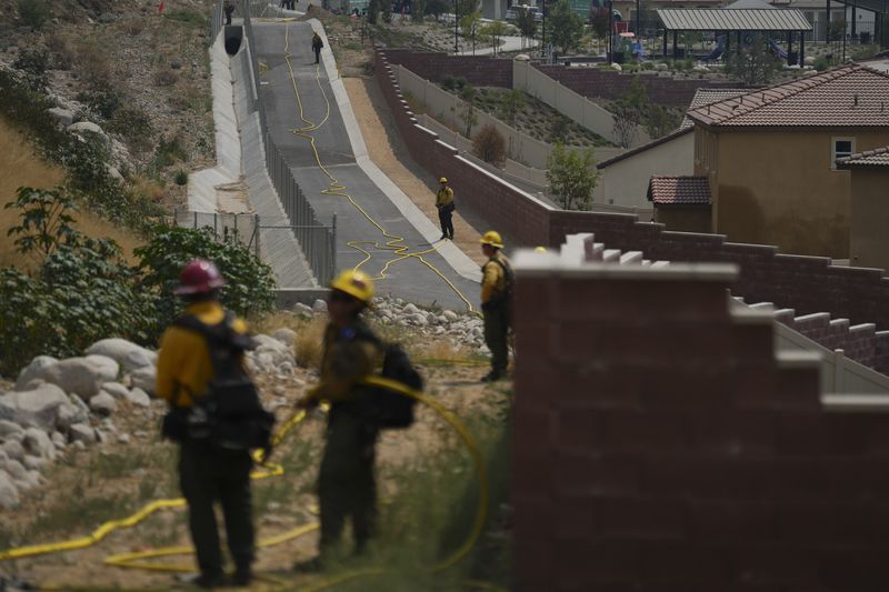 Fire crews monitor the Line Fire Saturday, Sept. 7, 2024, in Highland, Calif. (AP Photo/Eric Thayer)