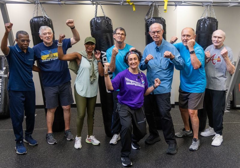 Rock Steady Boxing Instructor Nausheen Quraishy(center, foreground) poses with her class at Wellstar Health Place on the campus of Kennestone Hospital. She runs an exercise class for people who have been diagnosed with Parkinson's disease. Quraishy also has had severe health problems. She had a brain bleed 18 years ago and was stripped of her early memories. She and her students are doing all they can to help themselves.  The students are fighting to try to delay the progression of their disease. PHIL SKINNER FOR THE ATLANTA JOURNAL-CONSTITUTION