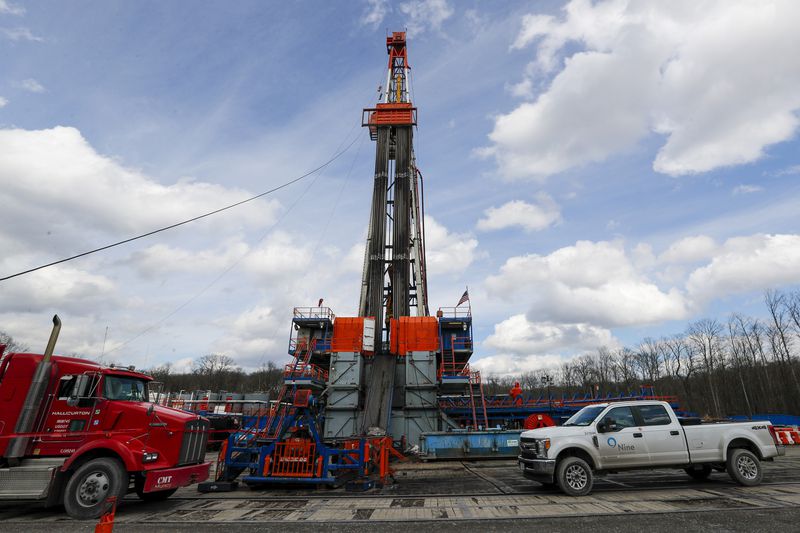 FILE - Work continues at a shale gas well drilling site in St. Mary's, Pa., March 12, 2020. (AP Photo/Keith Srakocic, File)