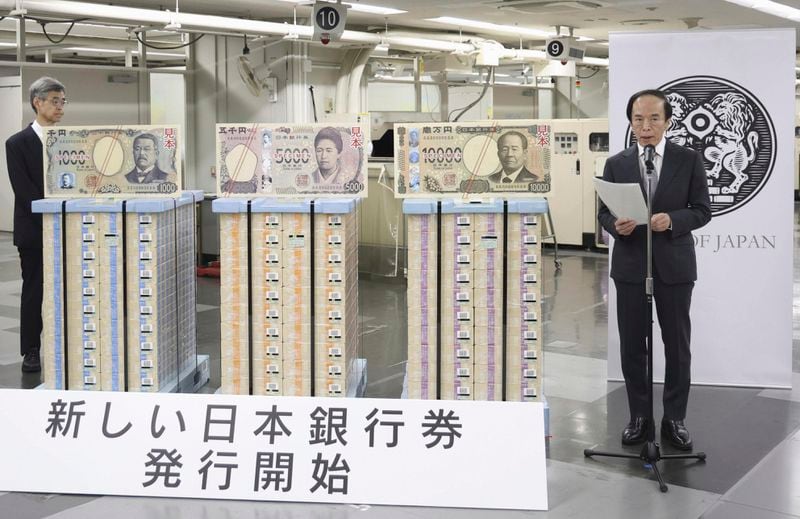 Bank of Japan Governor Kazuo Ueda delivers a speech during a ceremony marking the releases of new banknotes at the BOJ headquarters in Tokyo, Japan, Wednesday, July 3, 2024. The words at bottom read: New Bank of Japan banknotes start being issued. (Japan Pool/Kyodo News via AP)