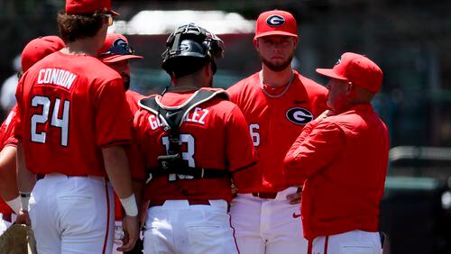 Georgia head coach Wes Johnson, right, talks with Georgia starting pitcher Kolten Smith, second from right, as Smith is removed from the mound against NC State in game one of the NCAA Super Regional at Foley Field Saturday in Athens. NC State scored eleven runs in the second inning. (Jason Getz / AJC)
