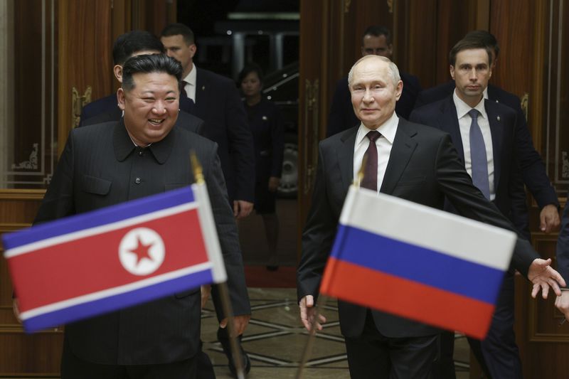 FILE - Russian President Vladimir Putin, right, and North Korea's leader Kim Jong Un smile during their meeting at the Pyongyang Sunan International Airport outside Pyongyang, North Korea, on June 19, 2024. Kim and Putin signed a major defense deal that observers worry could embolden Kim to direct more provocations at South Korea. (Gavriil Grigorov, Sputnik, Kremlin Pool Photo via AP, File)