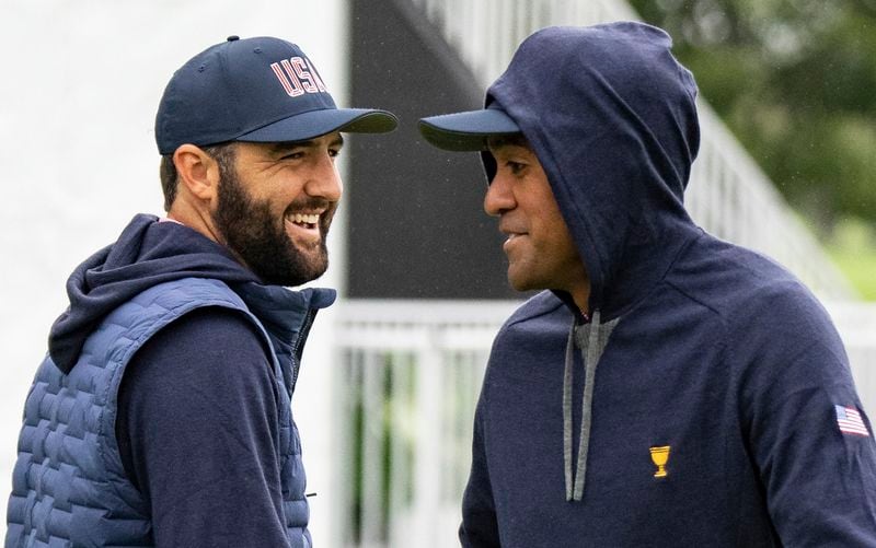 United States team members Scottie Scheffler, left, and Tony Finau share a laugh during practice for the Presidents Cup golf tournament at Royal Montreal Golf Club in Montreal, Wednesday, Sept. 25, 2024. (Christinne Muschi/The Canadian Press via AP)