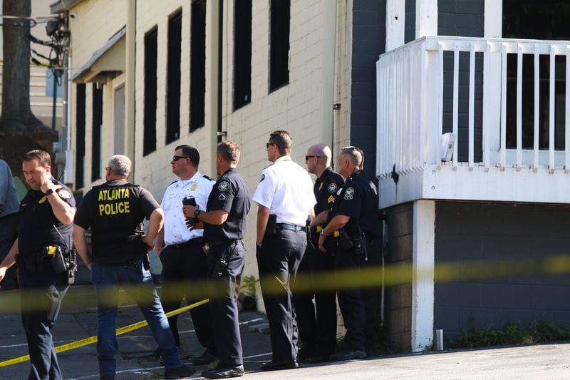 Crime scene tape blocks off the parking lot to a row of businesses in the Bennett Street Shopping Center where a man was found dead Monday morning. 