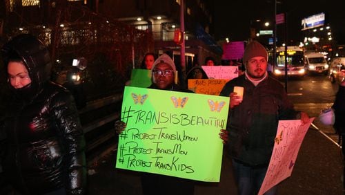 Sean Ebony Coleman (middle) holds a sign during a march for Transgender Day of Remembrance. He's the founder of Atlanta's new LGBTQ+ center Destination Tomorrow South. The center opened last May. (Photo courtesy of Destination Tomorrow)
