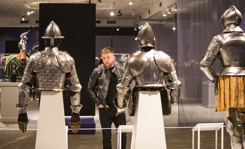 Taking a closer look at several suits of armor, Charles Mescher is in attendance at ”Knights in Armor" a traveling exhibit of European armor from the 1500s is on display at Fernbank Museum and open to the public on Friday, Feb 11, 2022.  (Jenni Girtman for The Atlanta Journal-Constitution)