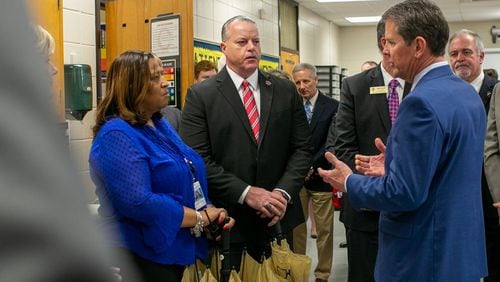 Gov. Brian Kemp speaks to McEachern High School Principal Regina Montgomery and Cobb County Superintendent Chris Ragsdale during a tour of McEachern High School in Powder Springs on Thursday, Feb. 13, 2020. REBECCA WRIGHT / FOR THE AJC