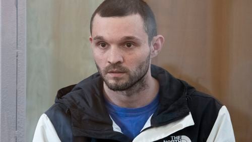 U.S. Army Staff Sgt. Gordon Black sits in a glass cage in courtroom in Vladivostok, Russia, on Wednesday, June 19, 2024. Black is on trial on charges of theft and threatening murder in a dispute with a Russian woman. Russian state media reported that he denied the allegation of threatening murder but "partially" admitted to theft. (AP Photo)