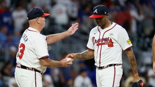 Atlanta Braves pitcher Raisel Iglesias is removed from the mound by manager Brian Snitker after allowing five runs during the ninth inning at Truist Park on Sunday, Sept. 15, 2024, in Atlanta. 
(Miguel Martinez/ AJC)