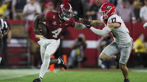 Alabama quarterback Jalen Milroe (4) runs for a first down against Georgia defensive back Dan Jackson (17) during the second quarter at Bryant-Denny Stadium, Saturday, Sept. 28, 2024, in Tuscaloosa, Al. (Jason Getz / AJC)

