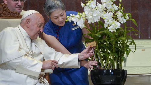 Chief Executive Officer of the Singapore's National Parks Board Hwang Yu-Ning presents Pope Francis with a 'Dendrobium His Holiness Pope Francis', a specially bred orchid variety named after him at the Parliament House in Singapore, Thursday, Sept. 12, 2024. Pope Francis flew to Singapore on Wednesday for the final leg of his trip through Asia, arriving in one of the world's richest countries from one of its poorest after a record-setting final Mass in East Timor. (AP Photo/Gregorio Borgia)