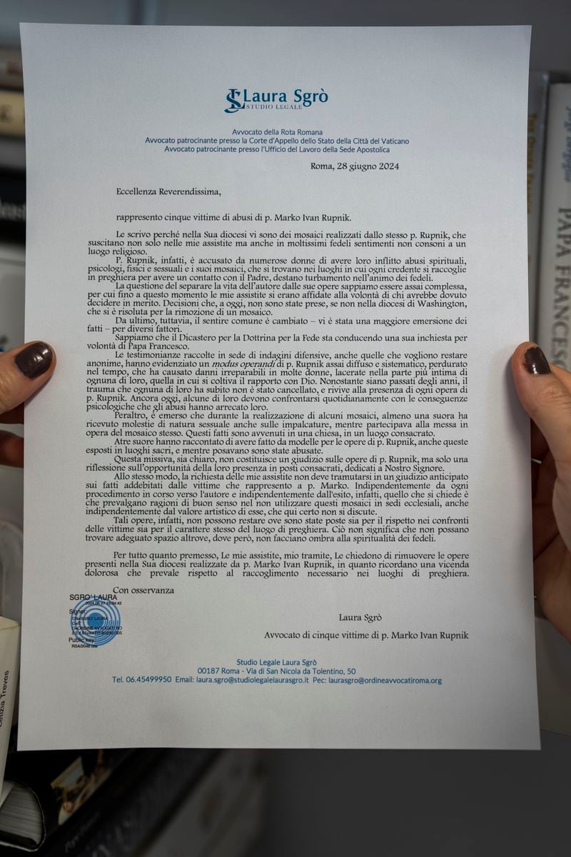 This photo taken Thursday, June 27, 2024, in Rome shows a copy of a letter obtained by The Associated Press and written by an Italian lawyer representing five women who say they were psychologically, spiritually, and sexually abused by ex-Jesuit artist Rev. Marko Rupnik, that asks Catholic bishops around the world on Friday, June 28, 2024, to remove his mosaics from their churches, saying their continued display in places of worship was "inappropriate" and retraumatizing to victims. (AP Photo/Domenico Stinellis)