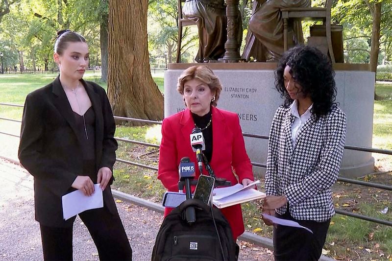 Flanked by Veronika Didusenko, left, and Danielle Hazel, right, attorney Gloria Allred, center, speaks during a news conference Monday, Sept. 16, 2024, in New York. (AP Photo/Joe Frederick)