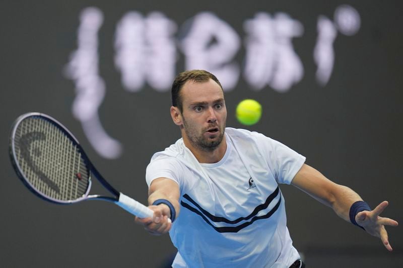 Roman Safiullin of Russia returns a shot from Jannick Sinner of Italy during the China Open tennis tournament held at the National Tennis Center in Beijing, Saturday, Sept. 28, 2024. (AP Photo/Ng Han Guan)