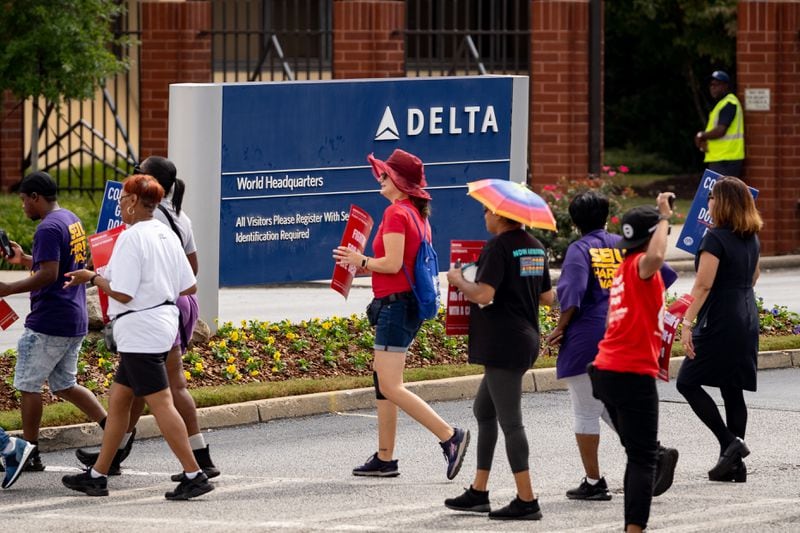 Endeavor Air flight attendants demonstrate outside of Delta headquarters in Atlanta. Demonstrators held signs and yelled chants demanding an end to tiered treatment. Thursday, Oct. 3, 2024. (Ben Hendren for the Atlanta Journal-Constitution)