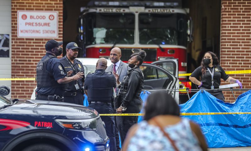 Homicide investigators collect evidence after a 19-year-old man was shot and killed May 6 in southwest Atlanta. The department has investigated 66 homicides since the start of the year. 
(John Spink / John.Spink@ajc.com)

