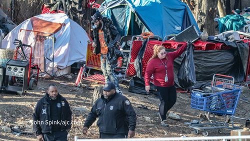 Atlanta Police and GDOT personnel clear a homeless encampment Monday.