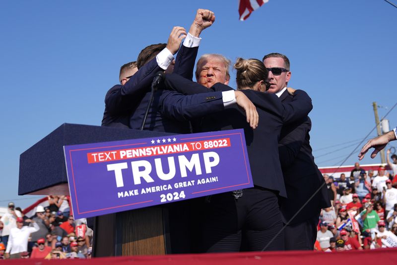 Republican presidential candidate former President Donald Trump is surrounded by U.S. Secret Service agents at a campaign rally, Saturday, July 13, 2024, in Butler, Pa. (AP Photo/Evan Vucci)