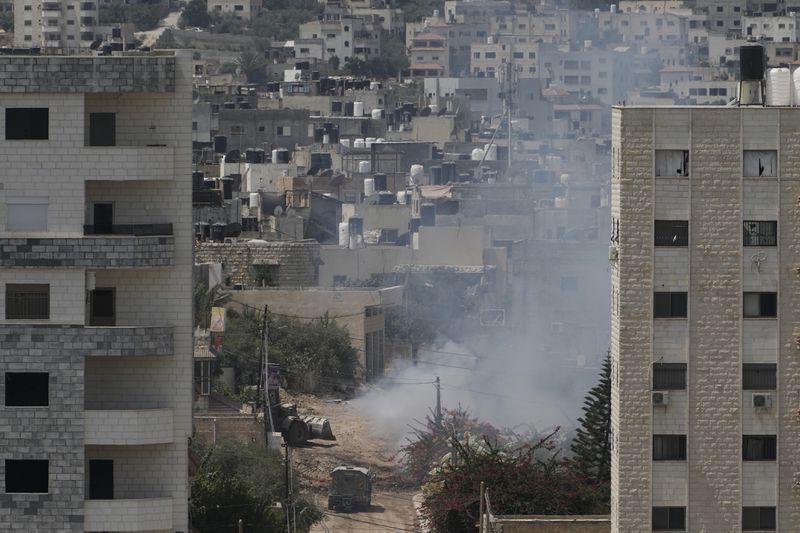 Smoke rises after an explosion during an Israeli military operation in the West Bank Jenin refugee camp, Saturday, Aug. 31, 2024. (AP Photo/Majdi Mohammed)