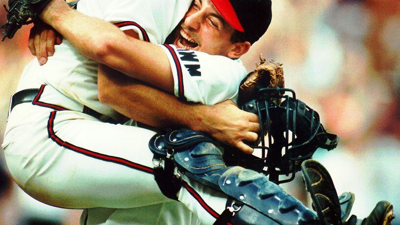 Atlanta Braves pitcher John Smoltz points towards catcher Greg Olson after  the Braves defeated the Pittsburgh Pirates, 4-0, to win Game 7 of the  National League playoffs at Three Rivers Stadium in