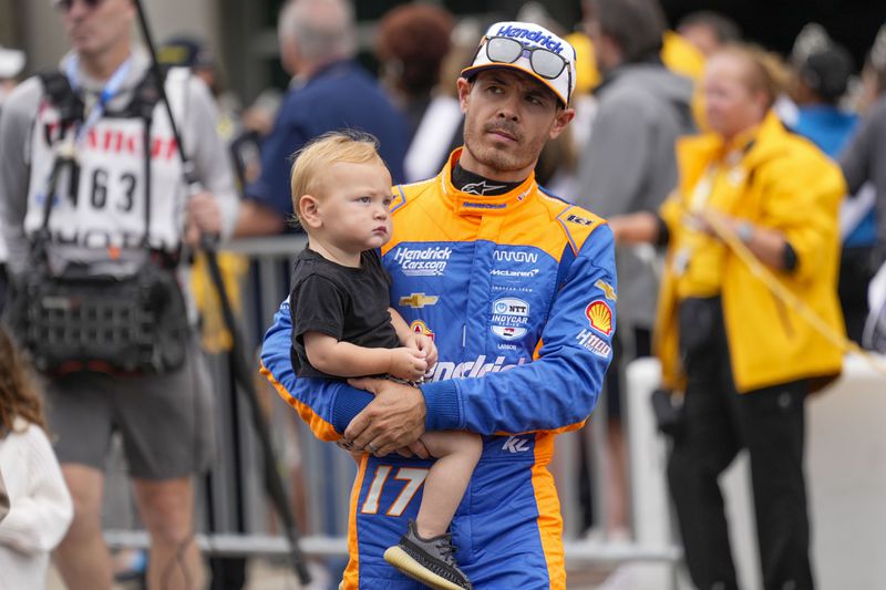 Kyle Larson walks out during driver introductions before the Indianapolis 500 auto race at Indianapolis Motor Speedway in Indianapolis, Sunday, May 26, 2024. (AP Photo/AJ Mast)