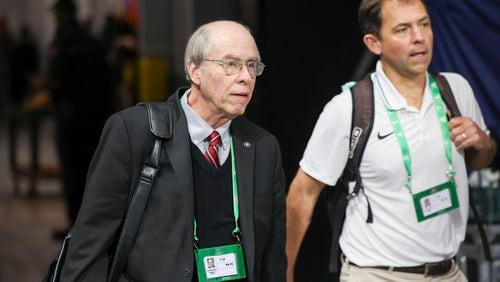 Leland Barrow (right) is now handling most of Georgia football responsibilities that Claude Felton (left) marshaled for 45 years before retiring earlier this year as the Bulldogs' senior associate athletic director for sports communication. Felton is shown here walking into Mercedes-Benz Stadium before Georgia’s game against Alabama in the 2023 SEC Championship at Mercedes-Benz Stadium last December. On Saturday, UGA will honor Felton by naming the fourth level of its new press box at Sanford Stadium after him. (Jason Getz / Jason.Getz@ajc.com)