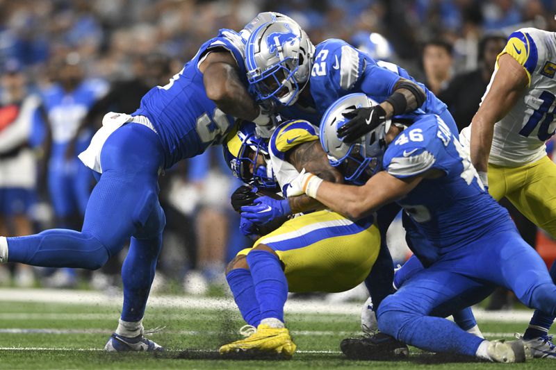 Los Angeles Rams running back Kyren Williams (23) is tackled by Detroit Lions cornerback Carlton Davis III (23) and linebacker Jack Campbell (46) during the second half of an NFL football game in Detroit, Sunday, Sept. 8, 2024. (AP Photo/David Dermer)