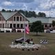 An aerial photo shows a makeshift memorial at Apalachee High School, Thursday, Sept. 19, 2024, in Winder. Students at Apalachee High School north of Atlanta will return to campus for half-days on Sept. 24, Barrow County school officials announced. (Hyosub Shin / AJC)