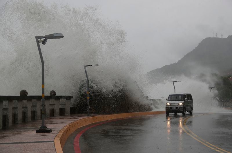 A car moves along the shore in Kaohsiung, southern Taiwan, Wednesday, Oct. 2, 2024, as Typhoon Krathon is expected to hit the area. (AP Photo/Chiang Ying-ying)