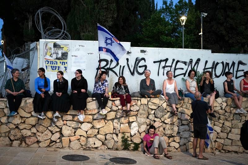 People attend a protest against Israeli Prime Minister Benjamin Netanyahu's government and demanding elections outside of the Knesset, Israel's parliament, in Jerusalem, Tuesday, June 18, 2024. (AP Photo/Ohad Zwigenberg)