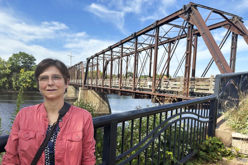 Stephanie Hirsch, city manager for Eau Claire, Wis., who supported the resettlement of refugees in the western Wisconsin city despite opposition from Republicans, poses in a downtown park ahead of a campaign visit from vice presidential candidate JD Vance Tuesday, Sept. 17, 2024. (AP Photo/Scott Bauer)