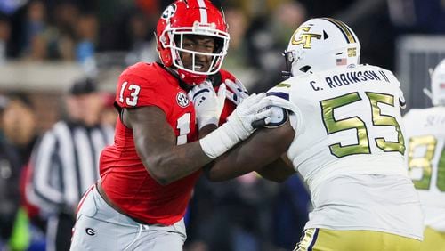 Georgia's Mykel Williams (13) goes against the blocking of Georgia Tech offensive lineman Corey Robinson II (55) during their game at Bobby Dodd Stadium, Saturday, November 25, 2023, in Atlanta. Georgia won 31-23. (Jason Getz / Jason.Getz@ajc.com)