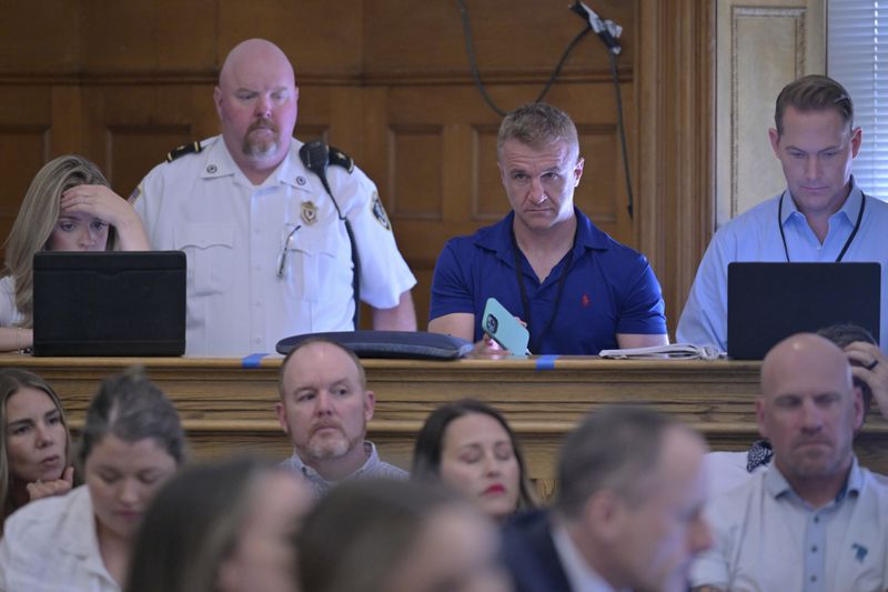 Blogger Aidan Kearney, second from right, listens from the press bench during Karen Read's murder trial in Norfolk Superior Court, Friday, June 21, 2024, in Dedham, Mass. Read, 44, is accused of running into her Boston police officer boyfriend with her SUV in the middle of a nor'easter and leaving him for dead after a night of heavy drinking. (AP Photo/Josh Reynolds, Pool)