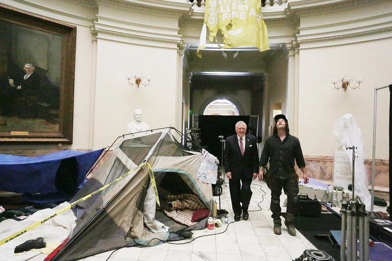 In 2018, "The Walking Dead" shot at the Gold Dome, turning the state capitol into a D.C. museum. Gov. Nathan Deal met with actor Norman Reedus on set. Courtesy WSB-TV