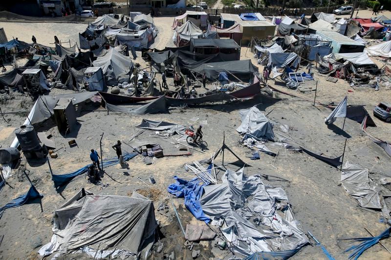 Palestinians inspect the damage at a site hit by an Israeli bombardment on Khan Younis, southern Gaza Strip, Saturday, July 13, 2024. Israel said it targeted Hamas’ shadowy military commander in a massive strike Saturday in the crowded southern Gaza Strip that killed at least 71 people, according to local health officials. Hamas immediately rejected the claim that Mohammed Deif was in the area. (AP Photo/Jehad Alshrafi)