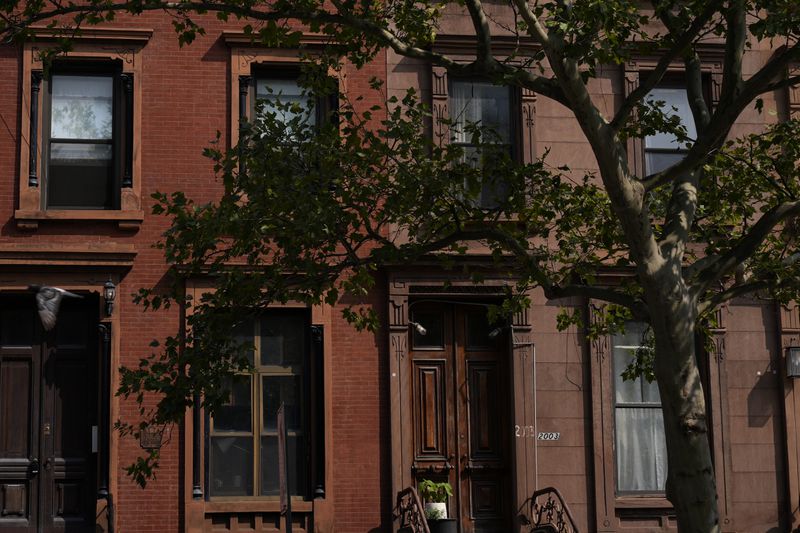 Houses in the Harlem neighborhood of New York are pictured Thursday, Aug. 15, 2024. (AP Photo/Pamela Smith)