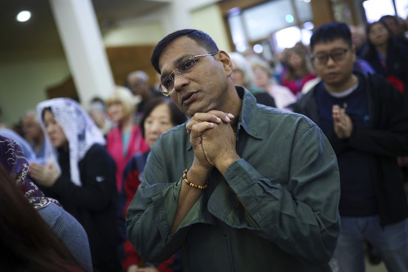 Pilgrims say their prayers inside the St. James Church in Medjugorje, Bosnia, Thursday, Sept. 19, 2024. (AP Photo/Armin Durgut)