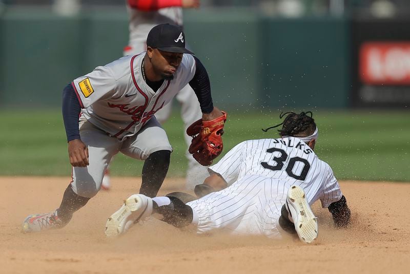 Chicago White Sox's Corey Julks is tagged out stealing second by Atlanta Braves' Ozzie Albies during the fifth inning of a baseball game Thursday, June 27, 2024, in Chicago. (AP Photo/Melissa Tamez)