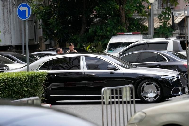 Former Thai Prime Minister Thaksin Shinawatra inside car leaves from Criminal Court in Bangkok, Thailand, Tuesday, June 18, 2024. Thaksin has been granted release on bail hours after he was formally indicted on a charge of defaming the country's monarchy in one of several court cases that have unsteadied Thai politics. (AP Photo/Sakchai Lalit)