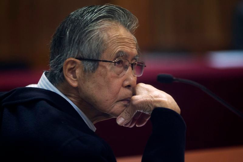 FILE - Peru's jailed, former President Alberto Fujimori, photographed through a glass window, attends his trial at a police base on the outskirts of Lima, Peru, June 28, 2016. (AP Photo/Martin Mejia, File)